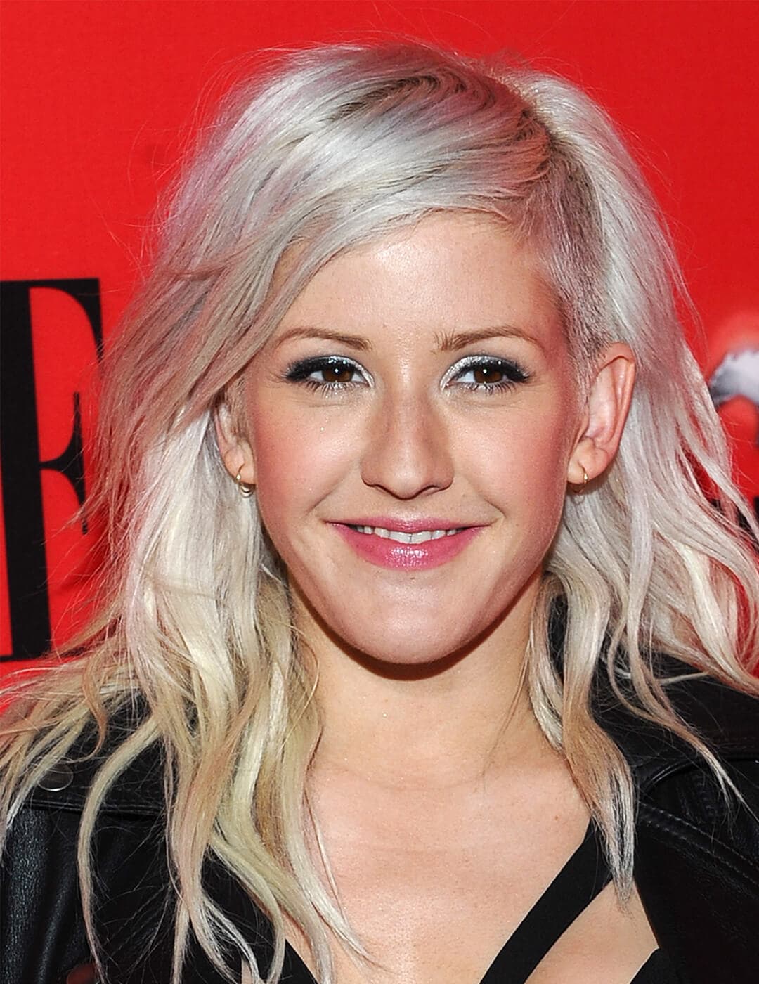 A photo of Ellie Goulding with a hidden undercut hairstyle waring a black dress