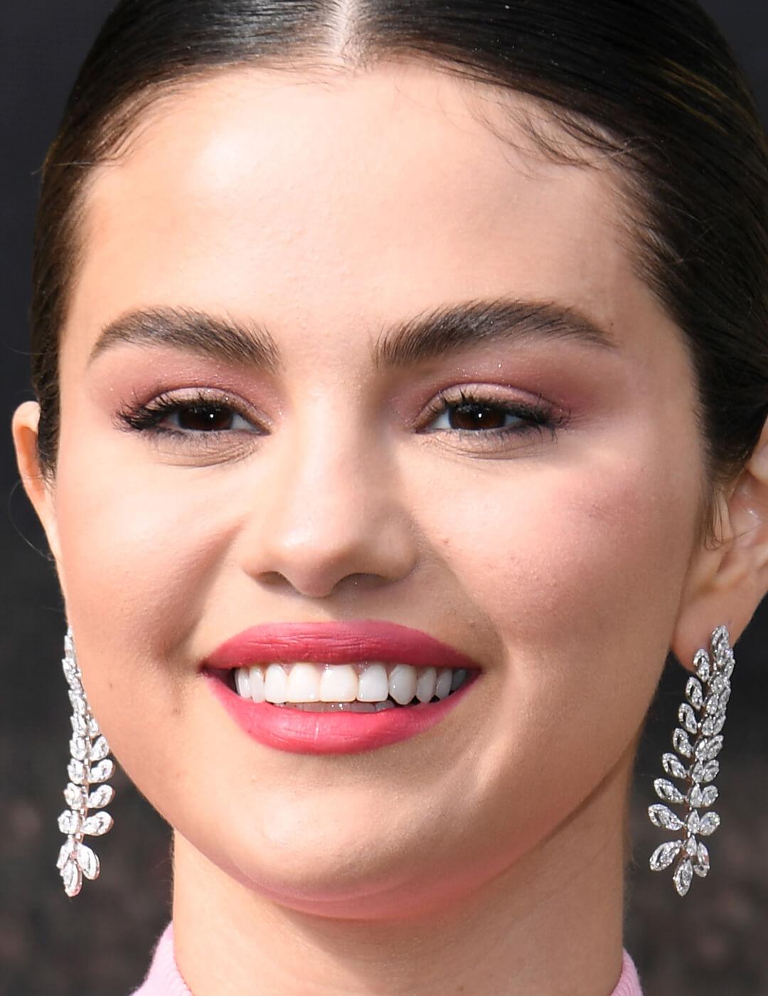 Selena Gomez rocking a soft pink eyeshadow makeup look paired with bright pink lips