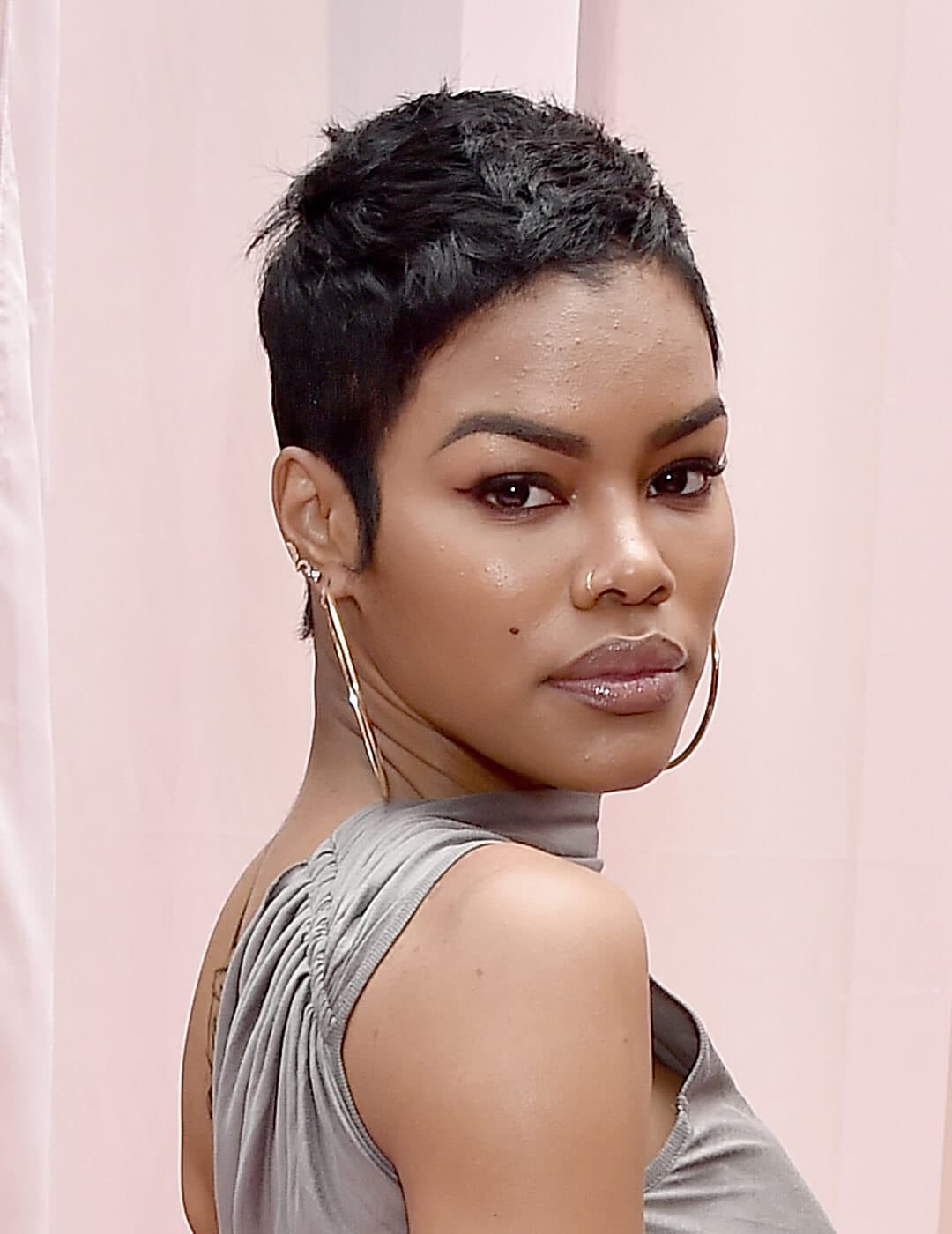 Teyana Taylor rocking her pixie cut hairstyle in a silver dress