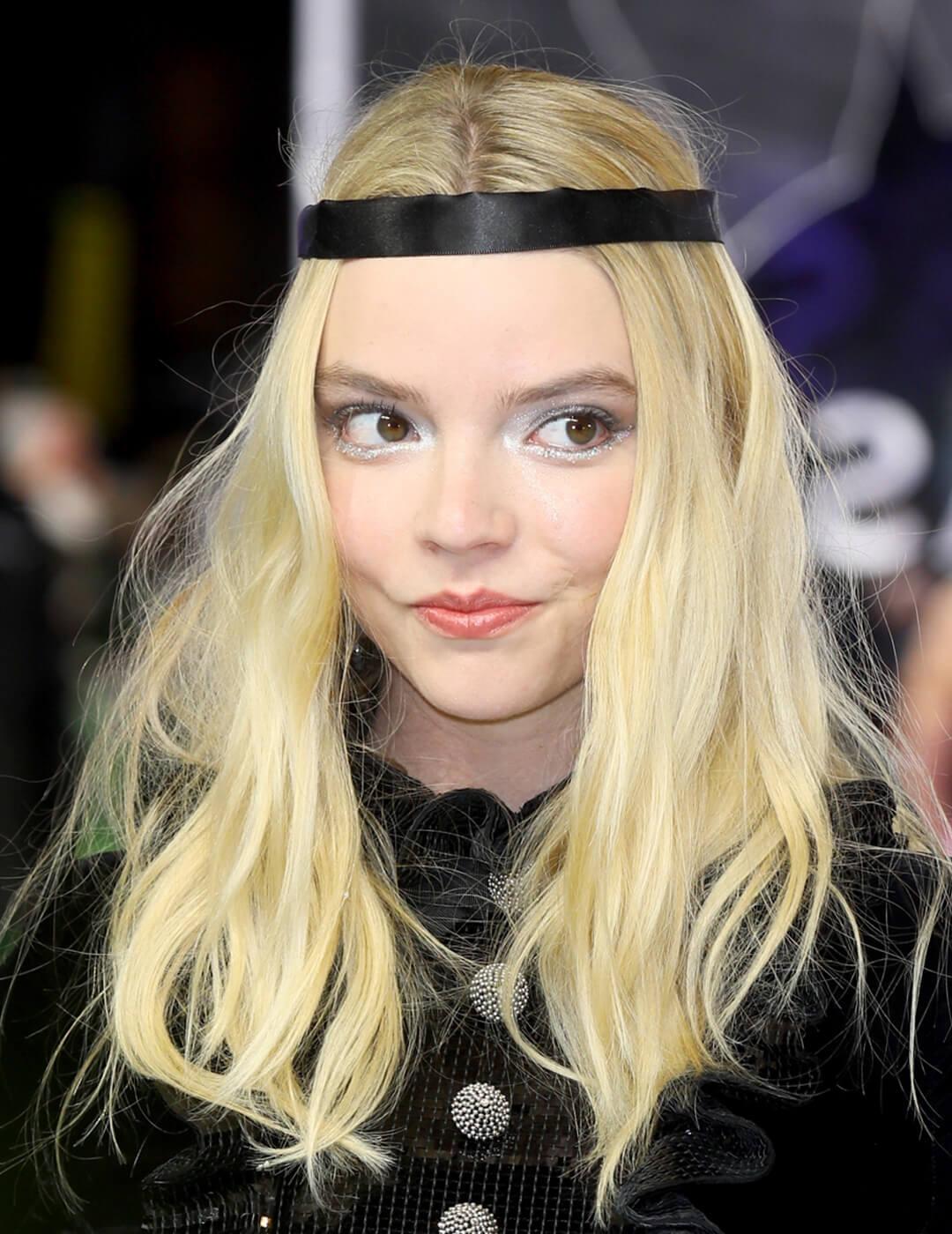 A photo of Anya Taylor-Joy looking cute on a baby blonde hair color