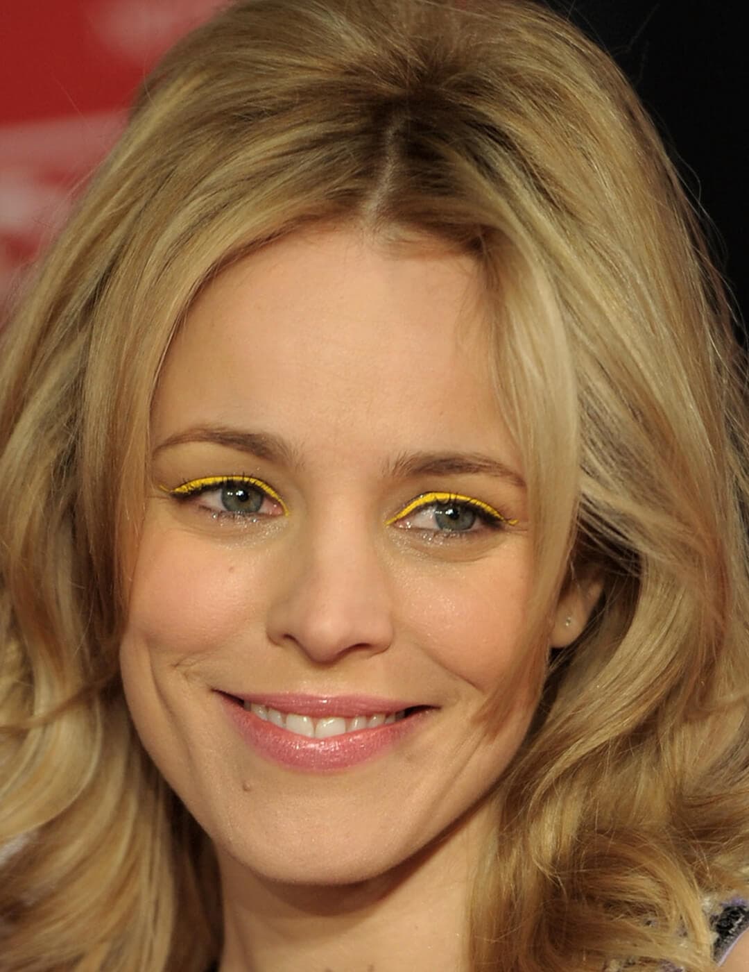 A photo of Rachel McAdams smiling in the camera with her yellow eyeshadow