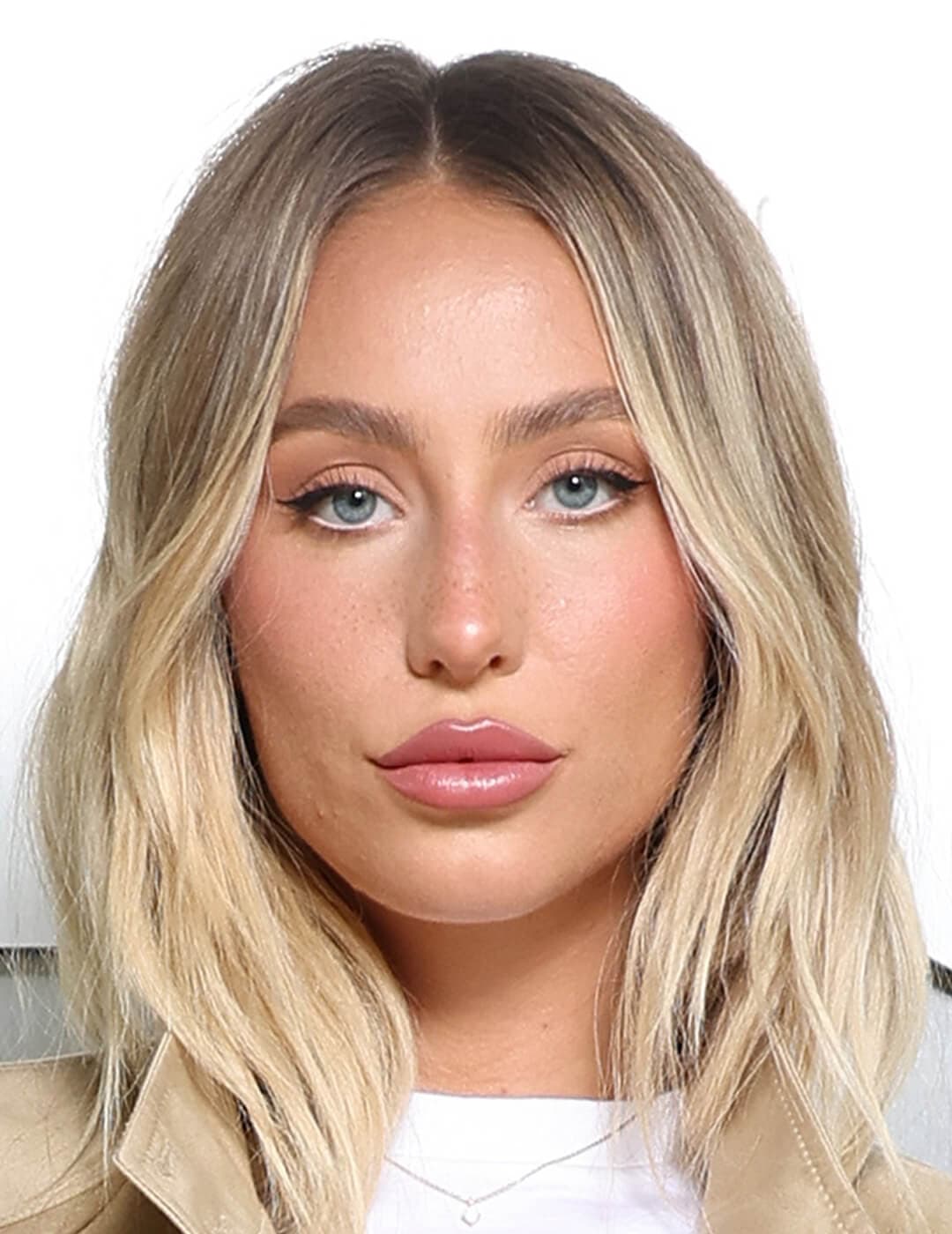 Close-up look of Alix Earle rocking a minimal face makeup with light pink lipstick, perfectly complementing her blond hair