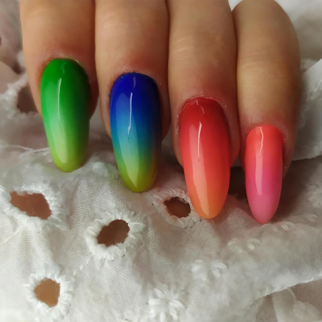 Close-up of a woman's rainbow ombré nail art