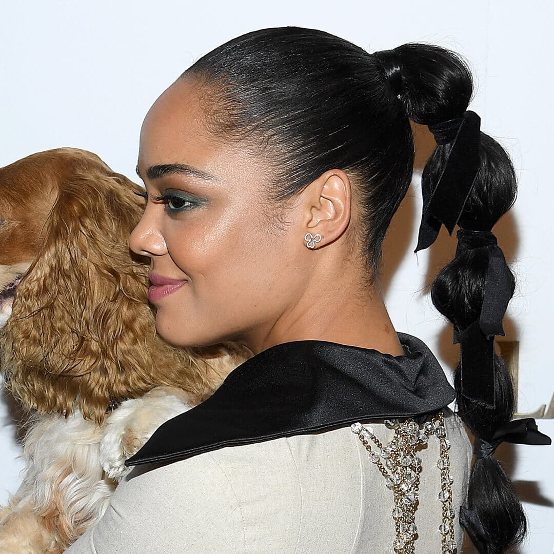 A photo of Tessa Thompson with bubble ponytail and black hair ties