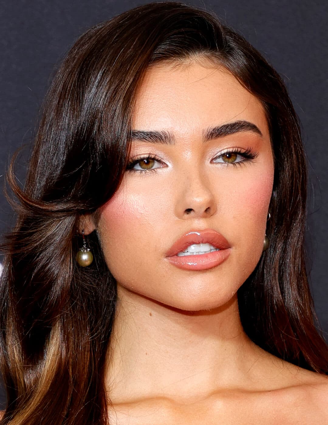 Madison Beer looking sultry in a pearlescent eyeshadow makeup look and glossy nude lips