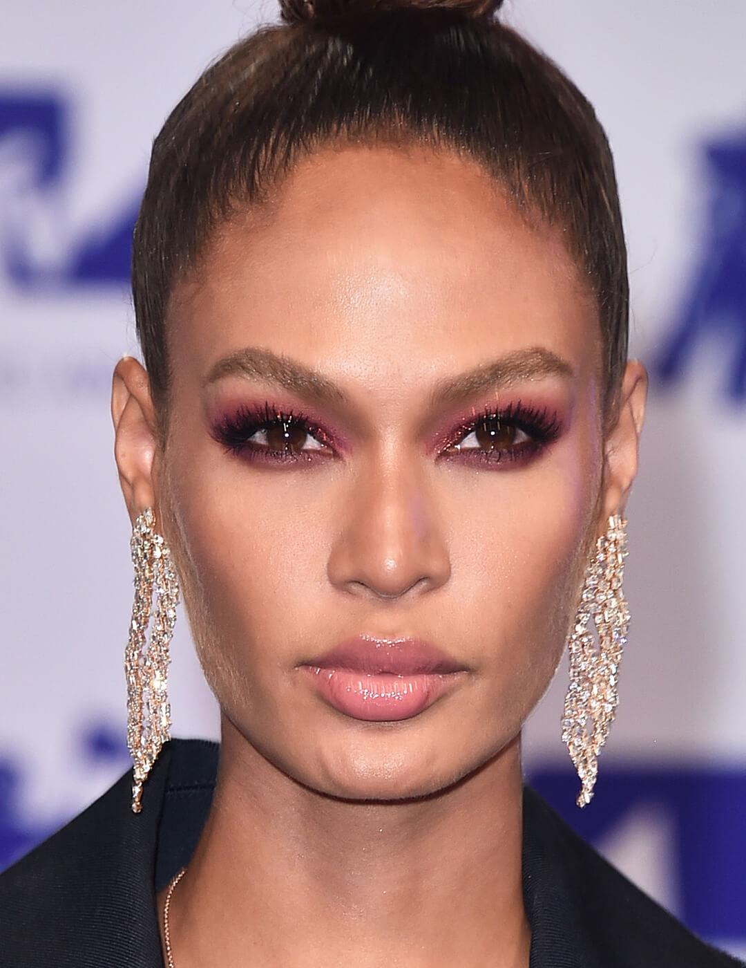Joan Smalls rocking a mauve smoky eye makeup look paired with nude lips