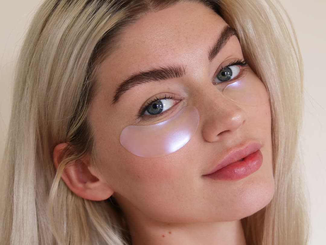 A close-up photo of a model with under-eye masks