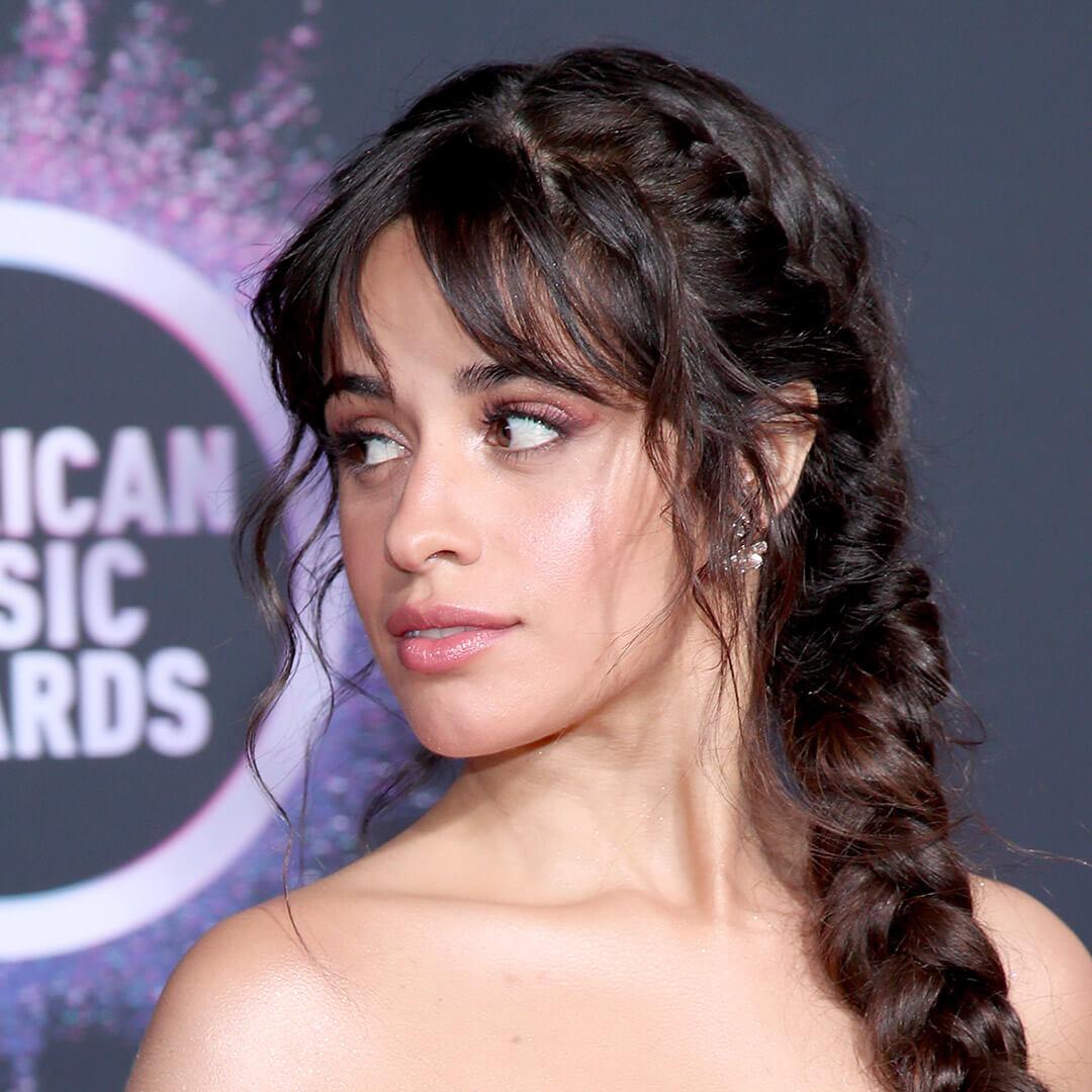 A photo of Camila Cabello with curtain bangs and a french braid