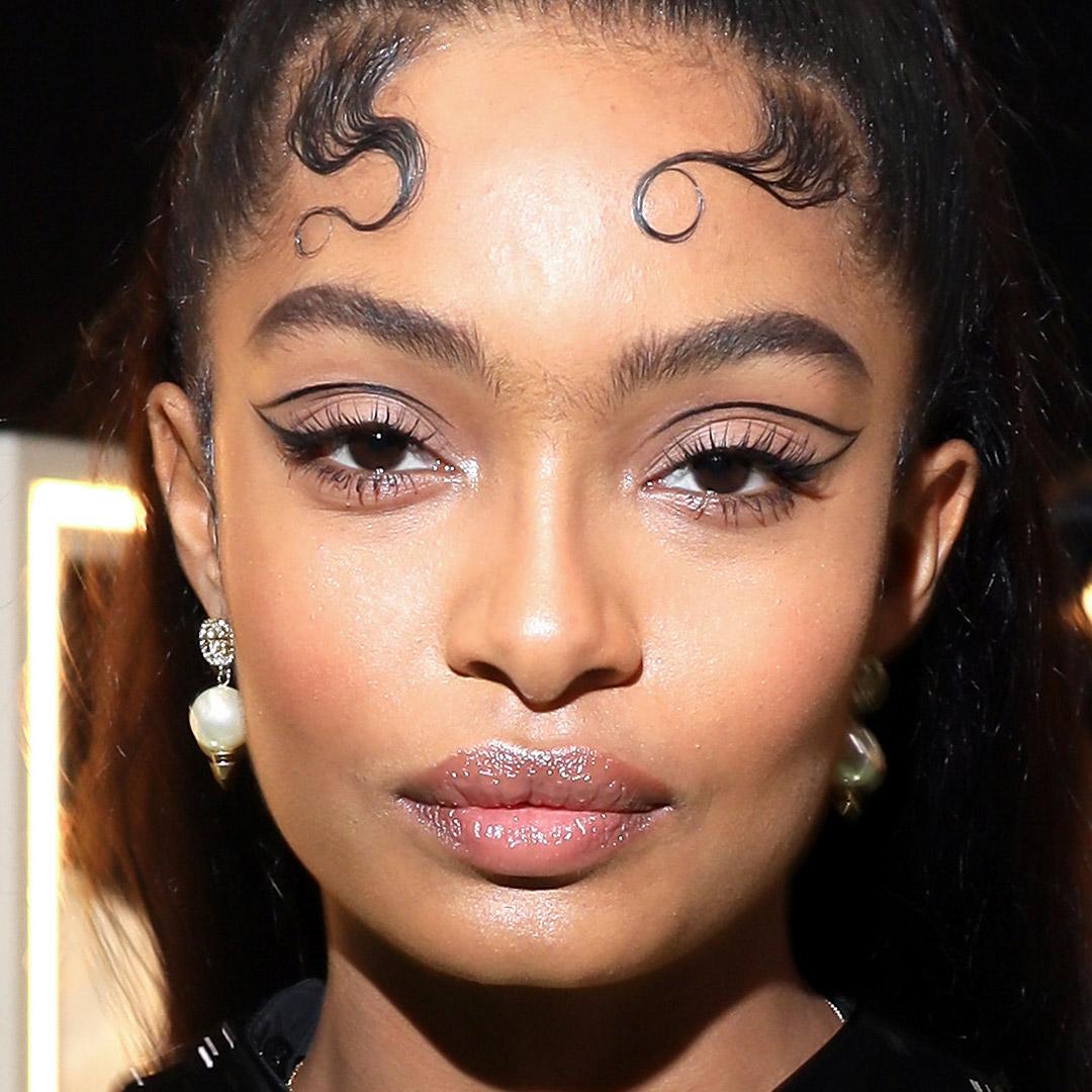 A photo of Yara Shahidi with a graphic eyeliner outline and nude eyeshadow and glossy lips