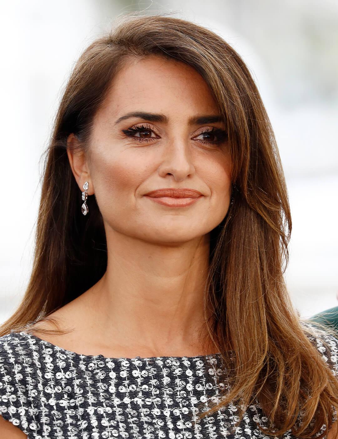 A photo of Penelope Cruz with side-swept bangs with a nude makeup look