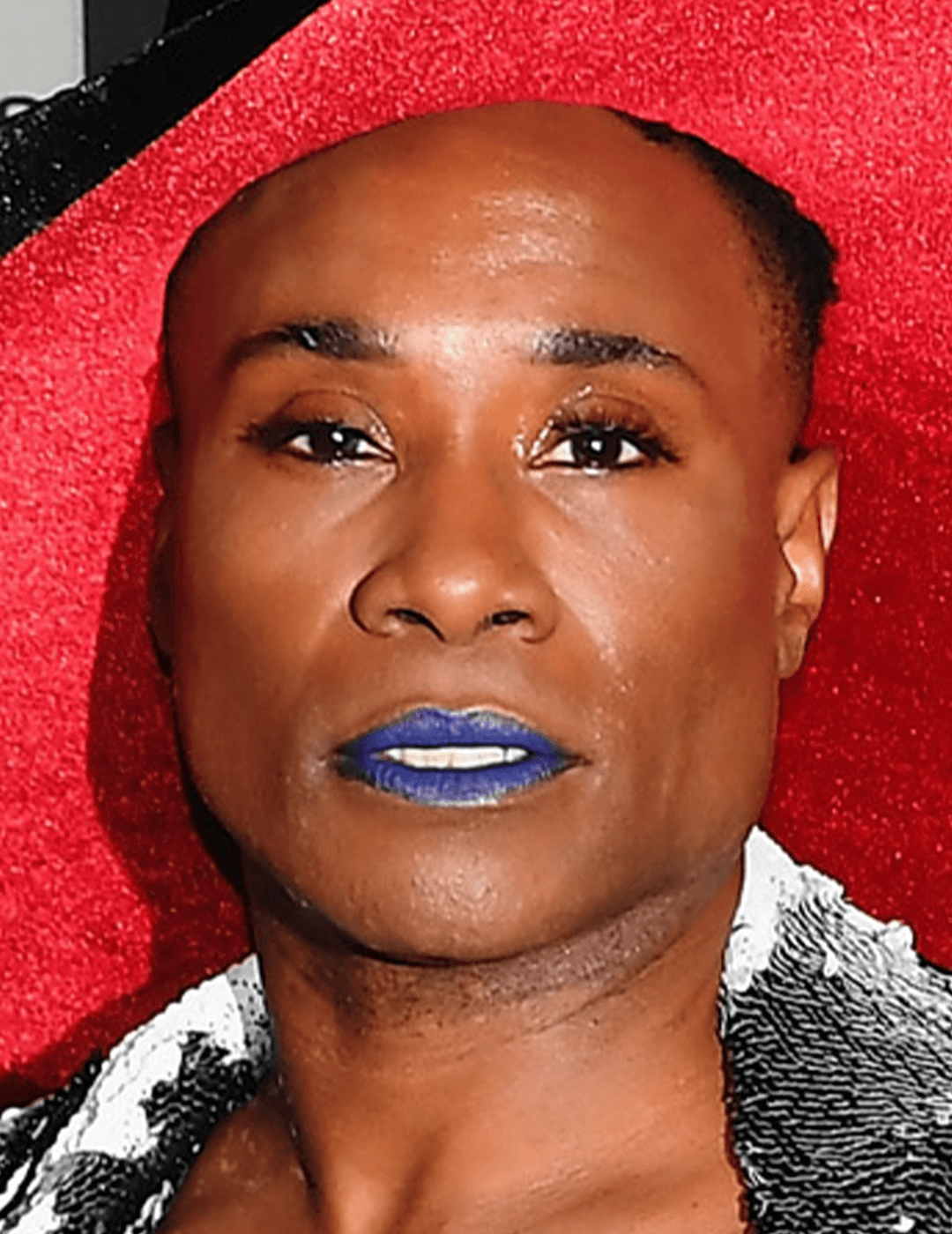 Close-up of Billy Porter rocking a red hat and navy blue lips