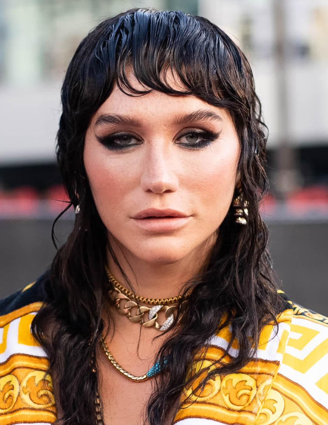 Kesha rocking a modern mullet hairstyle and smoky eyeshadow makeup look
