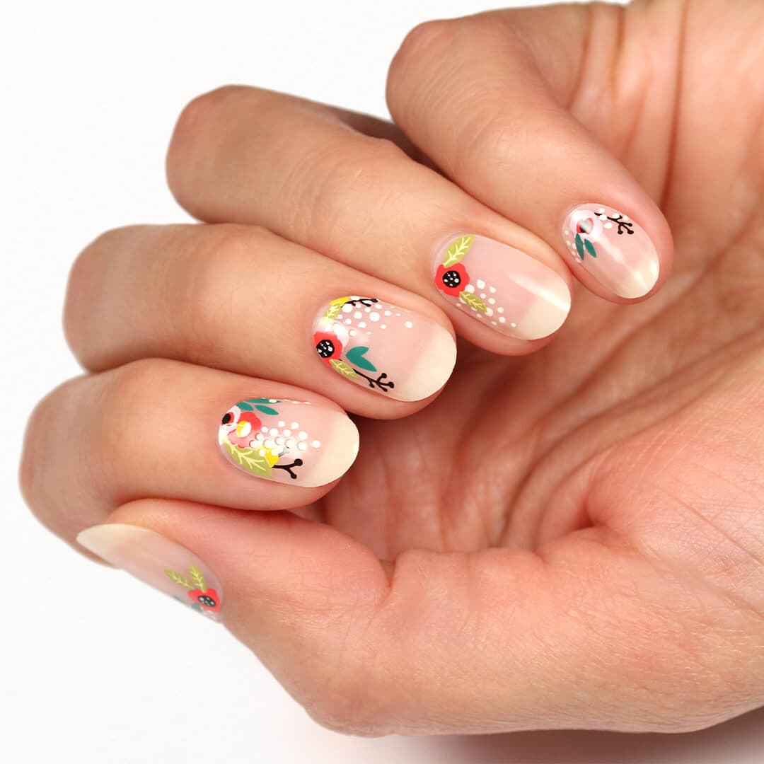 Close-up image of a model's hand with flower nail art