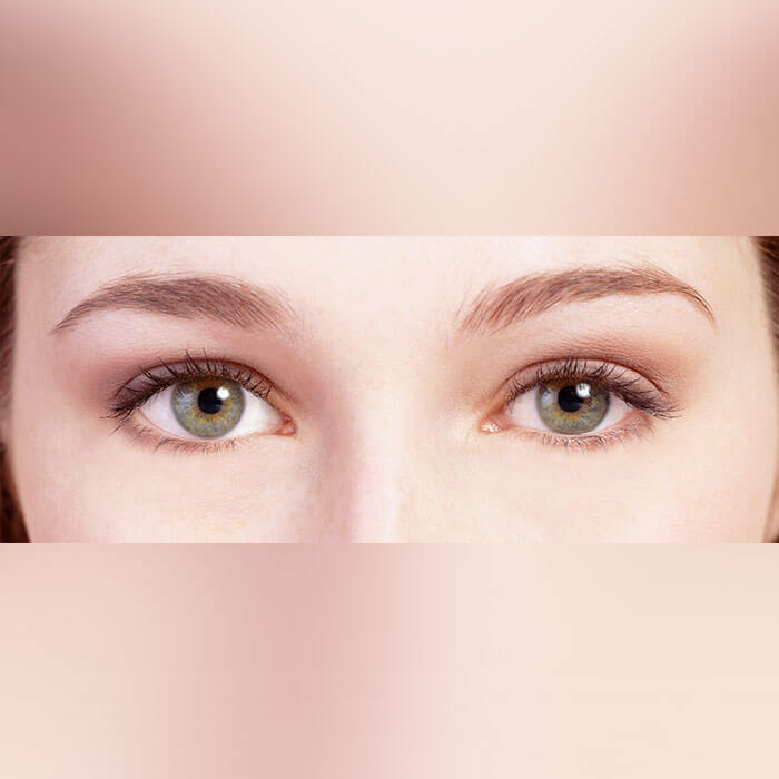 Tight shot focusing on the hazel eyes of a youthful woman