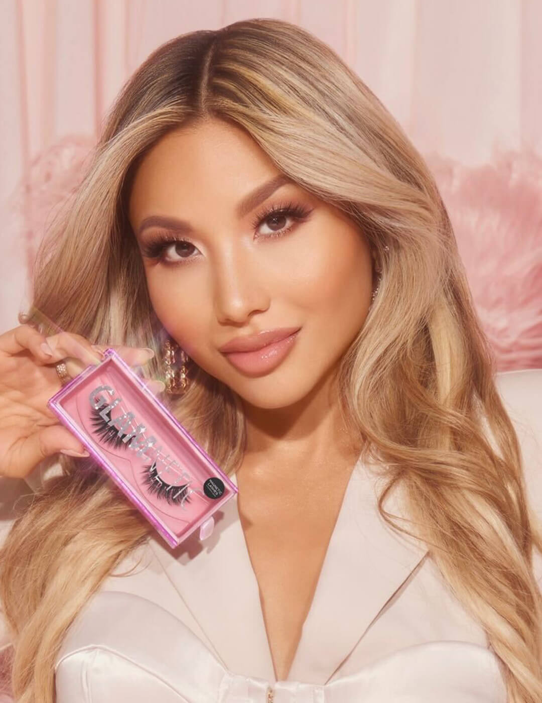 Portrait image of Ann McFerran holding GLAMNETIC false lashes