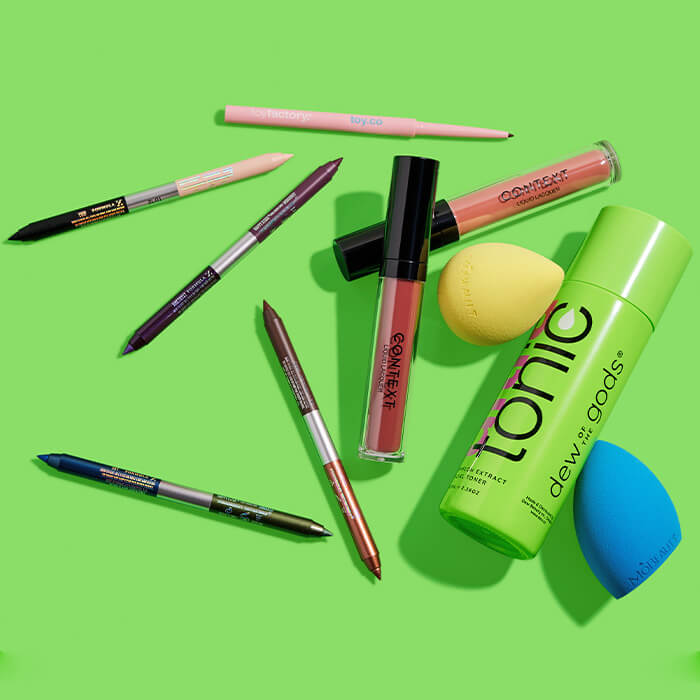 Makeup and skincare products and tools from various brands on lime green background