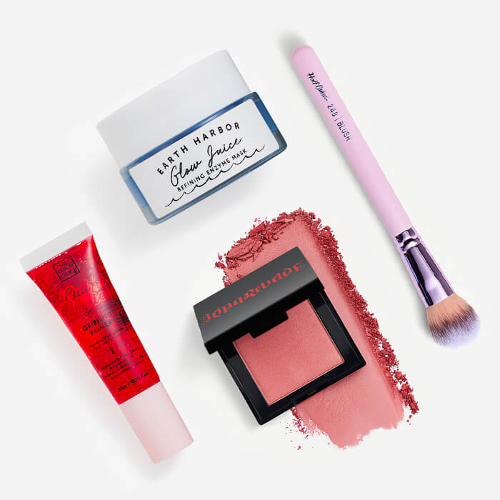 Makeup and skincare products and tools from the October 2023 IPSY Glam Bag on white background