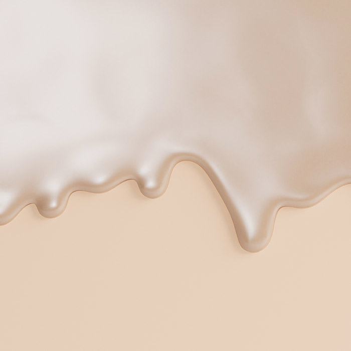 A photo of a cream-colored liquid foundation