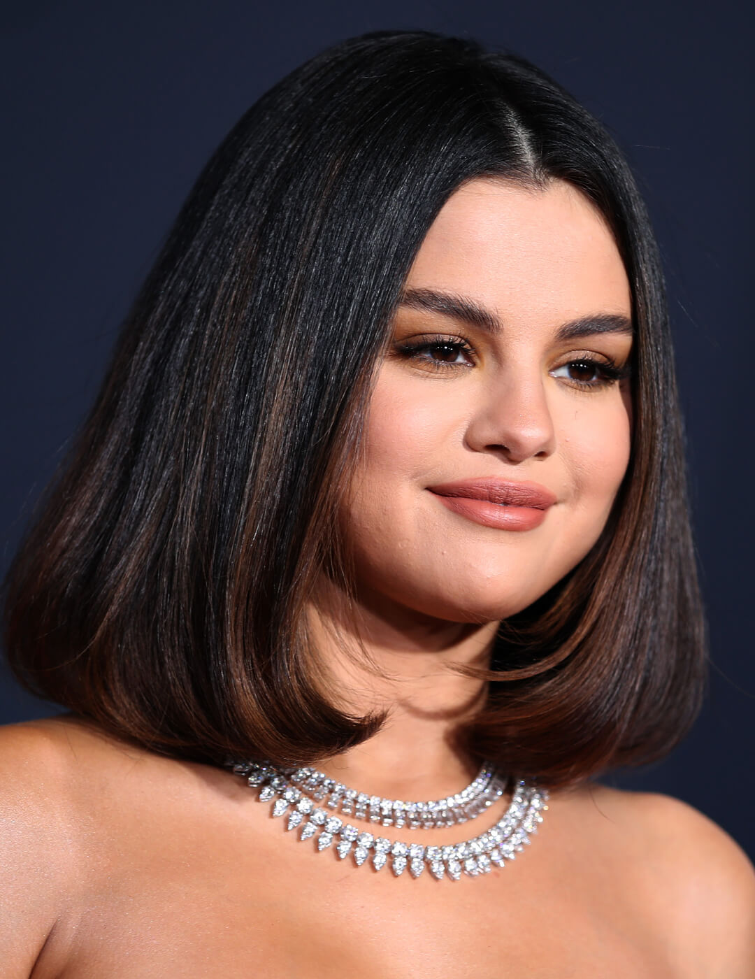 Selena Gomez smiling and rocking a blowout bob hairstyle