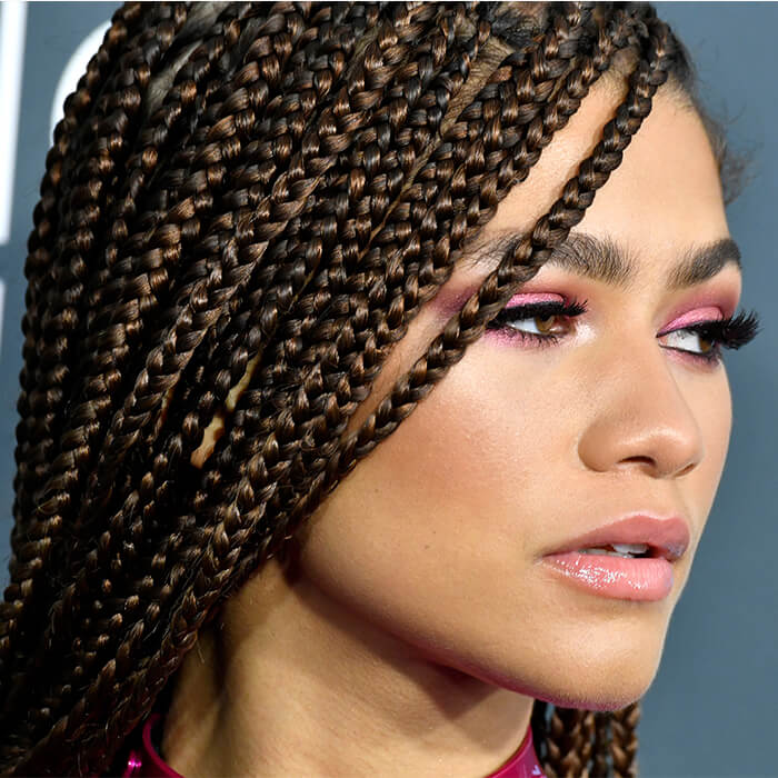 Close-up of Zendaya rocking the red carpet with a knotless braids hairstyle and shimmery pink eyeshadow makeup look