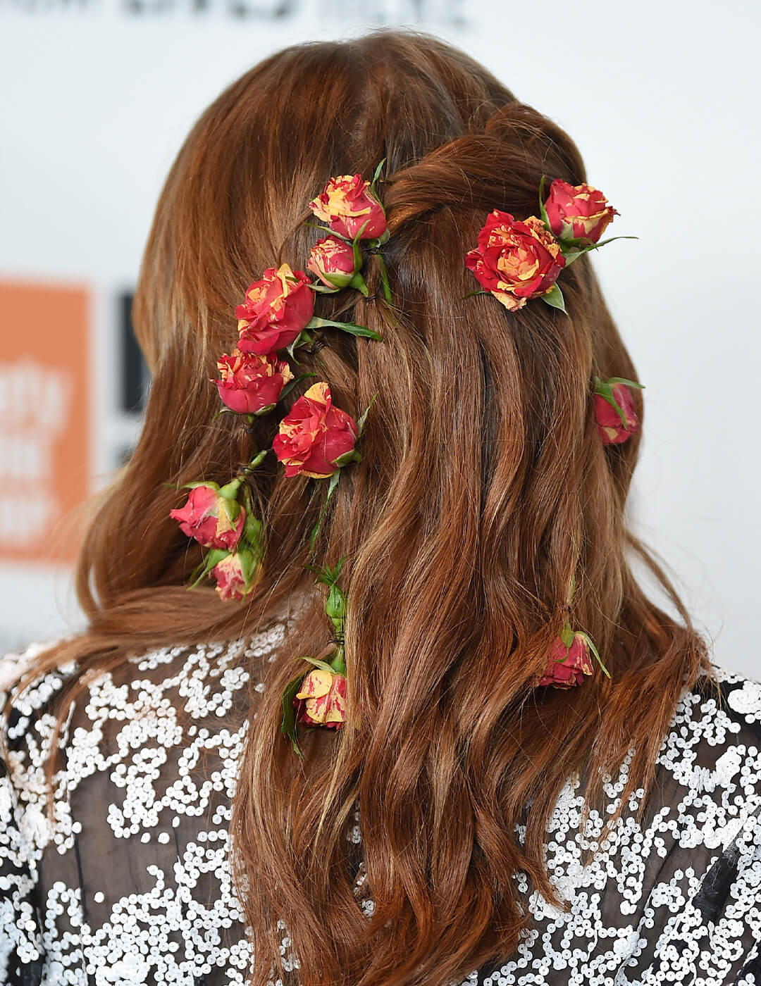 Back view of Emma Stone's hair embellished with flowers