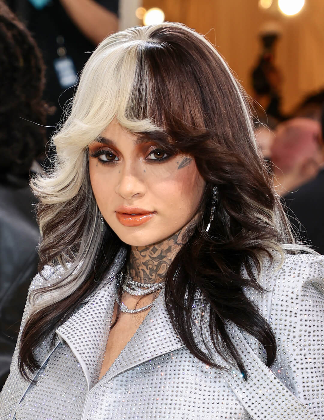 Kehlani rocking the red carpet in a black and white colored hairstyle and futuristic silver outfit