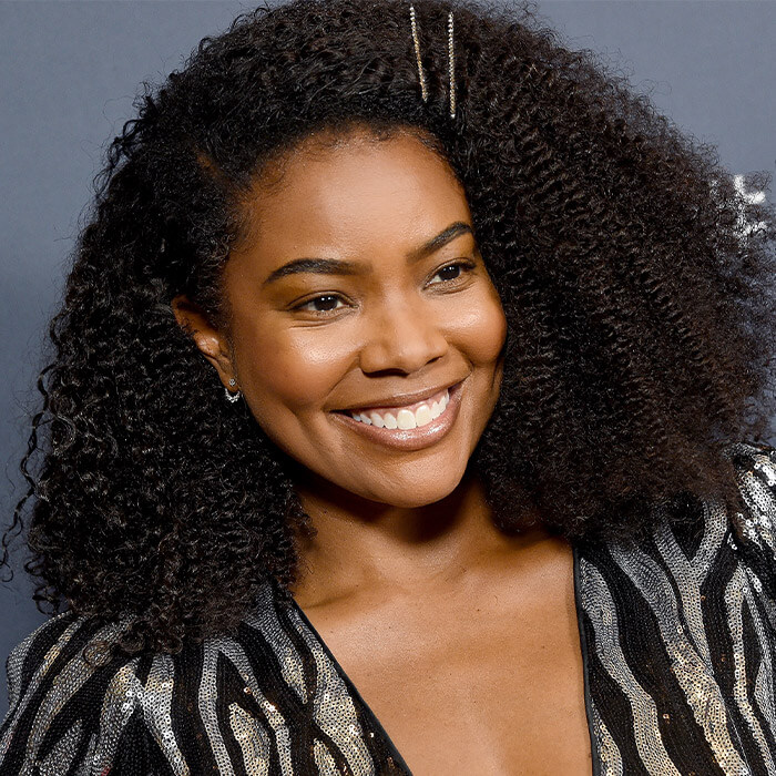 Gabrielle Union in a black and silver sequined dress smiling