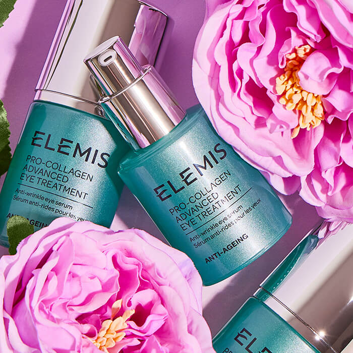 Bottles of ELEMIS Pro-Collagen Advanced Eye Treatment with pink flowers