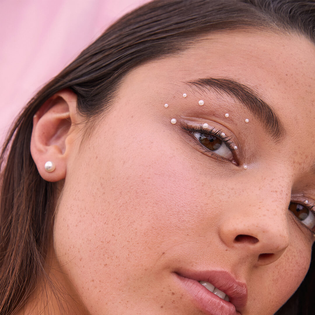 Close-up image of a model rocking a pearl-studded eye makeup look