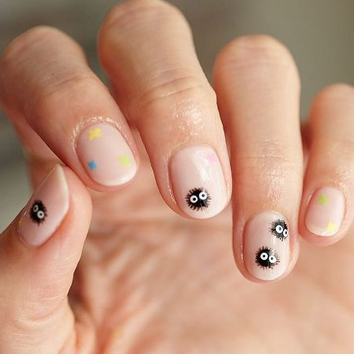 Close-up of a woman's hand with dust sprites nail art