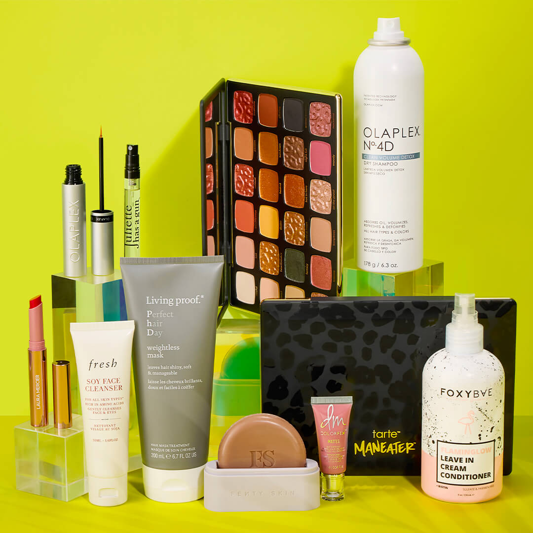 Skincare and makeup products from various brands on a green background