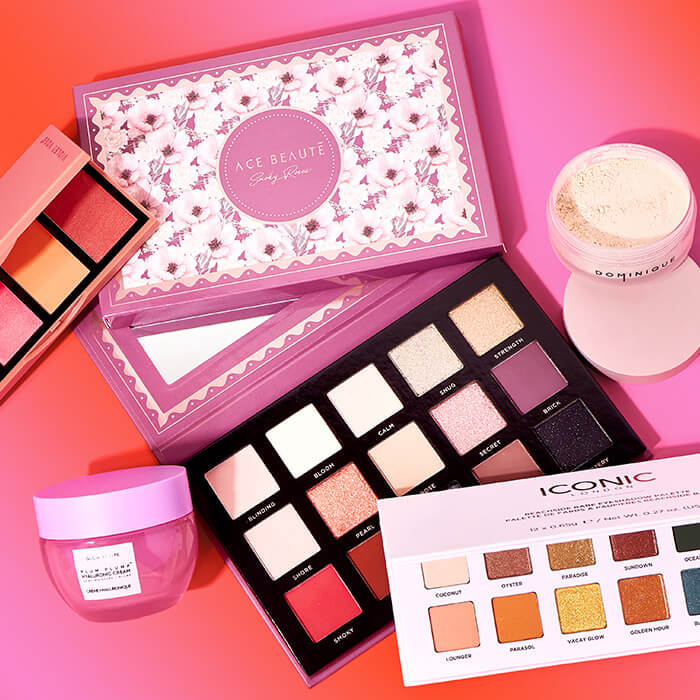 Beauty products from the May 2023 IPSY Glam Bag and BoxyCharm on pink background