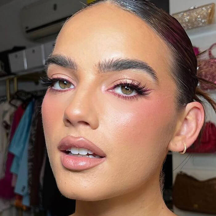 Young woman rocking a blushed makeup look; in her wardrobe