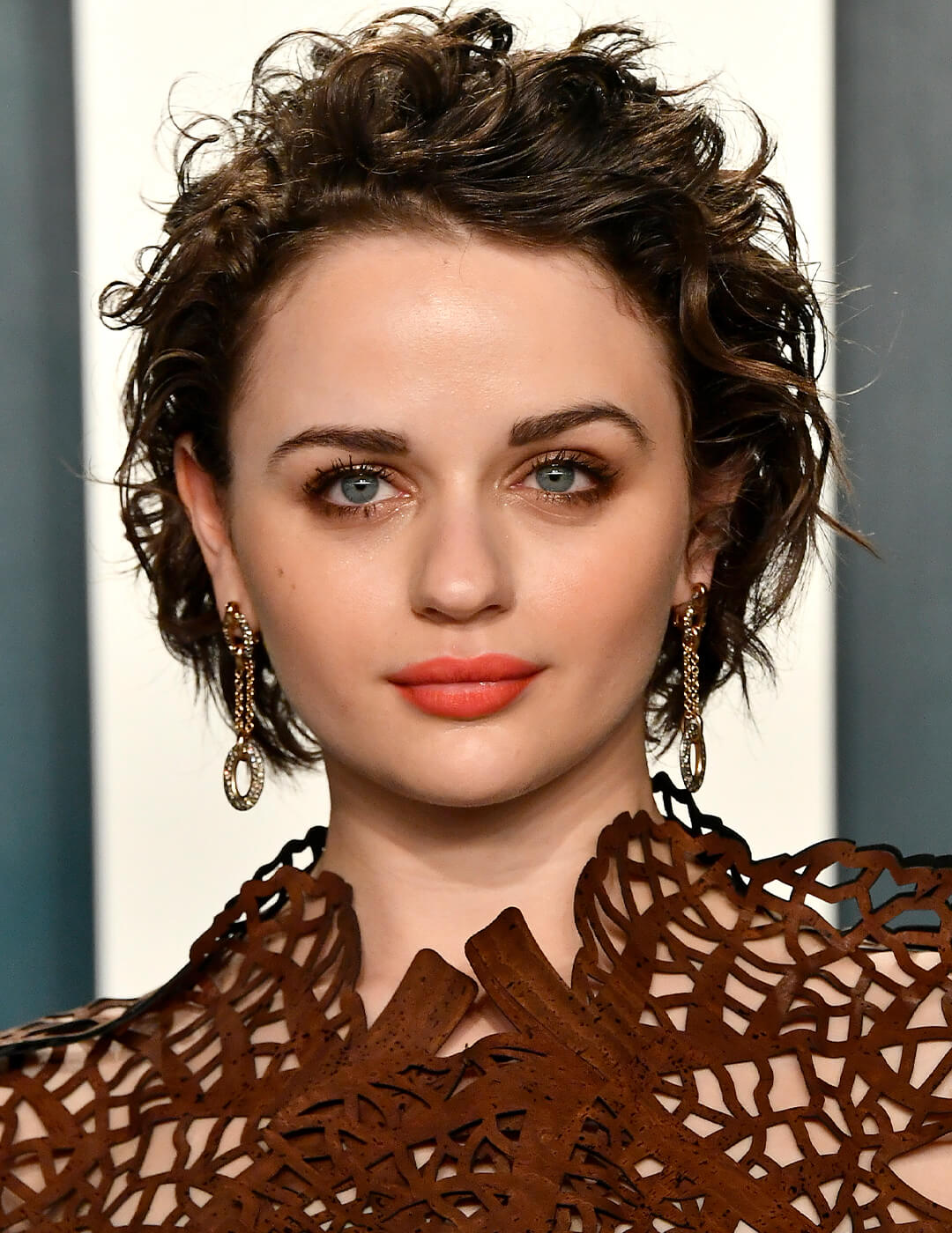 Joey King rocking a mermaid pixie hairstyle and a neutral eye makeup look paired with coral lips