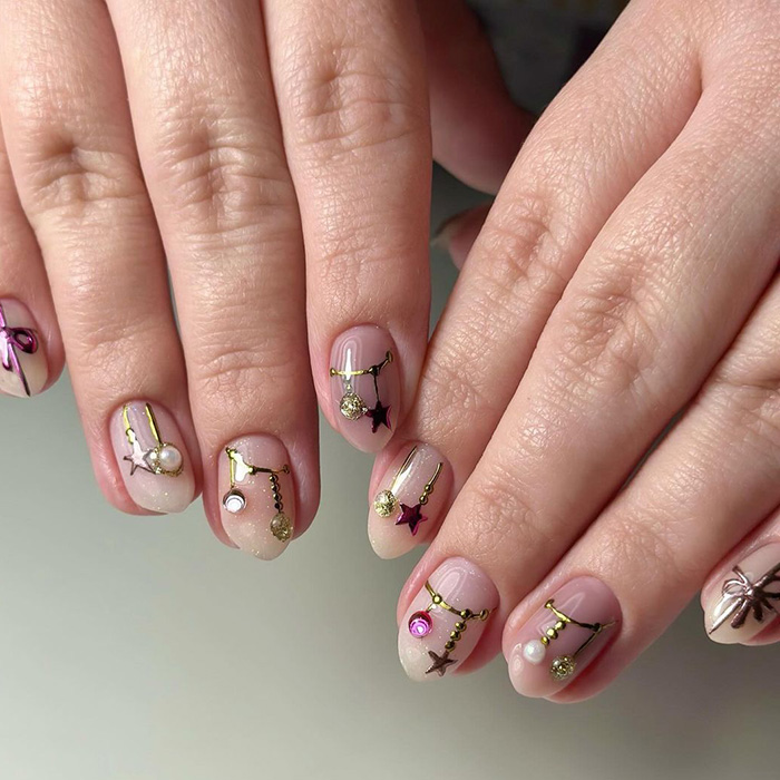 An image of hands with Christmas-inspired decorations as nail art