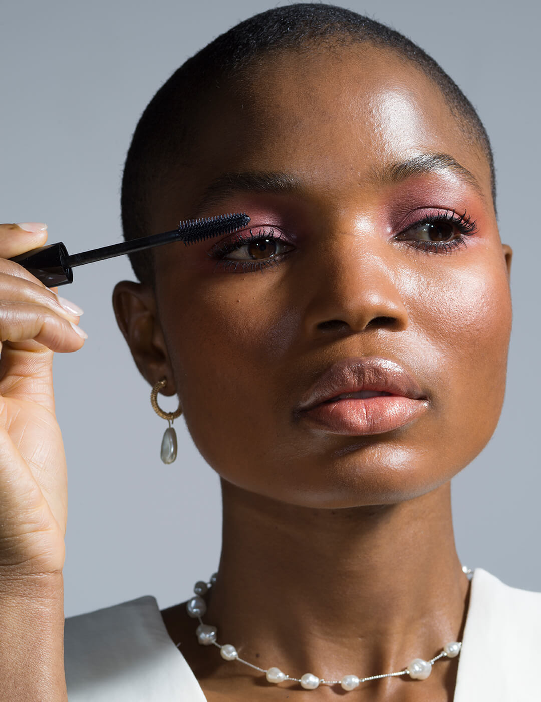 Head Shot Of Model Applying Mascara