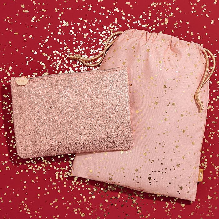 January 2021 IPSY Glam Bag and Glam Bag Plus on red surface with gold sequins and glitter