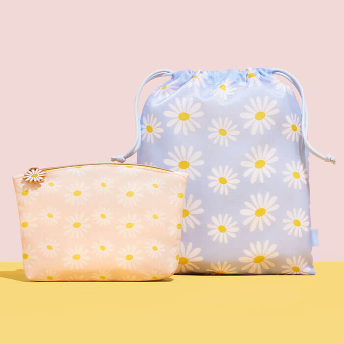 April 2022 IPSY Glam Bag and Glam Bag Plus bags on pink and yellow background