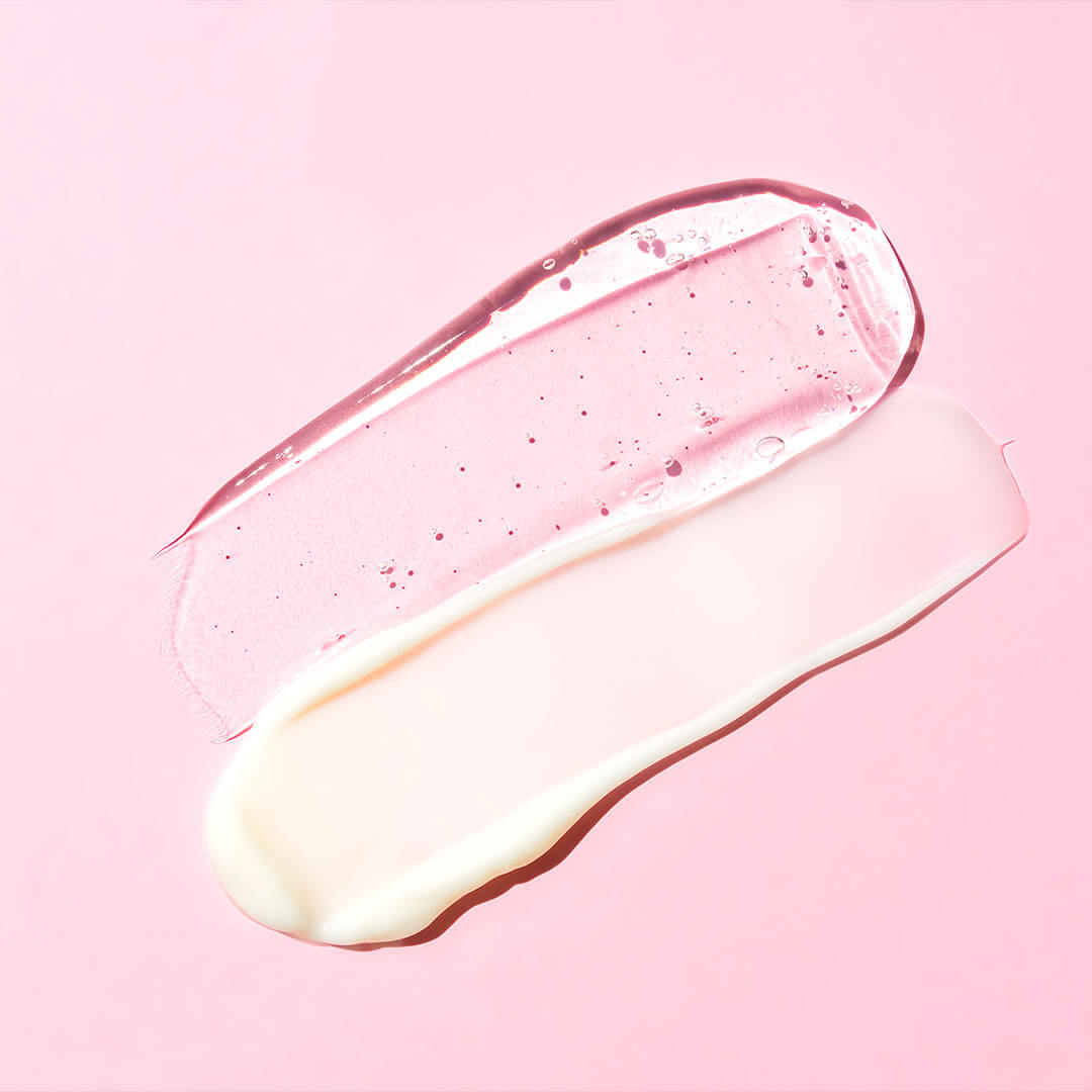 Two distinct skincare product textures, one a translucent gel and the other a smooth cream, are displayed against a pink backdrop