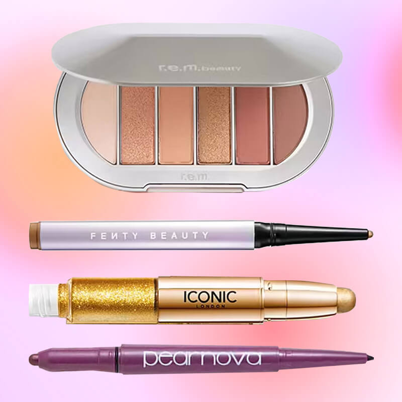 A close-up of various types of eyeshadow makeup against a pink gradient backdrop