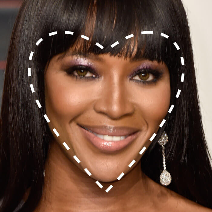 Close-up of a smiling Naomi Campbell with a broken lines heart shape overlay