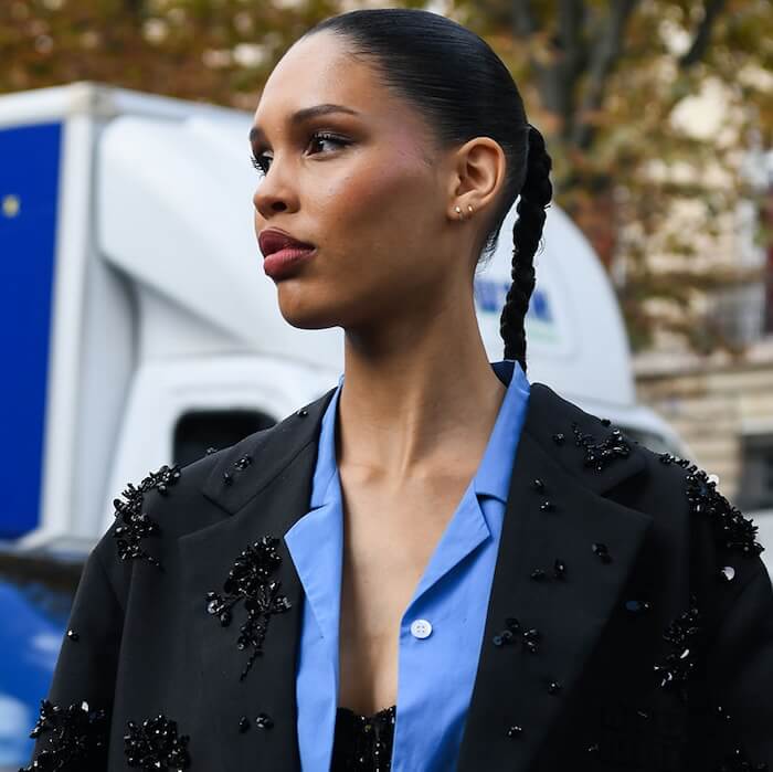 Nara Smith is wearing a black Miu Miu coat with pearls details, light blue shirt, black skirt, black bag outside Miu Miu with during Womenswear Spring/Summer 2025 as part of Paris Fashion Week on October 01, 2024 in Paris, France.