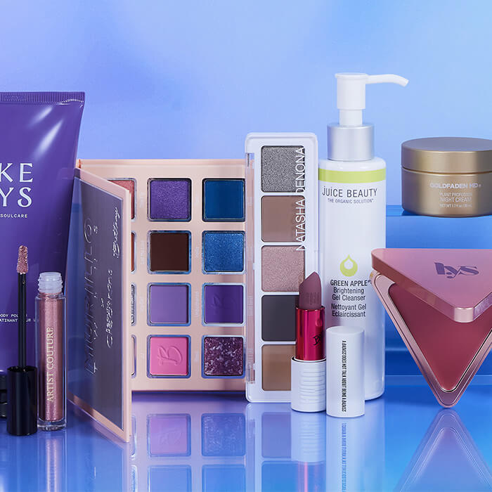Beauty products from various brands on reflective surface and sky background