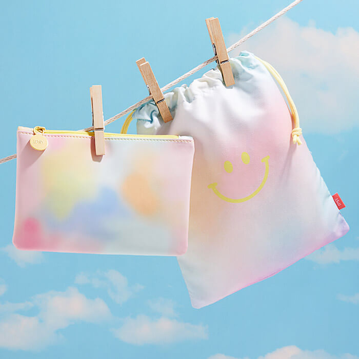 -January 2022 IPSY Glam Bag and Glam Bag Plus on clothes line against sky background
