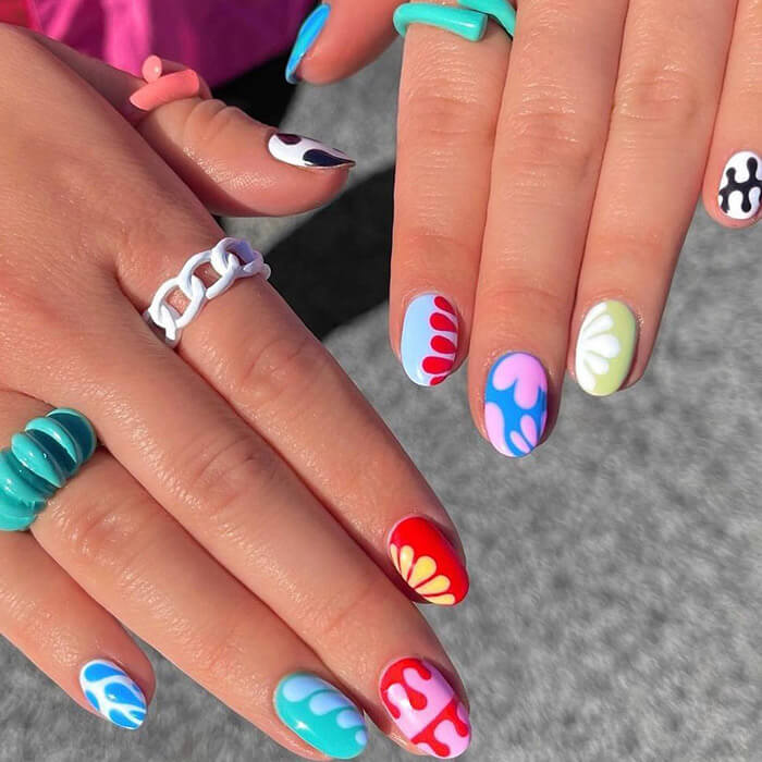 Close-up of woman's hands with cute and colorful nail art