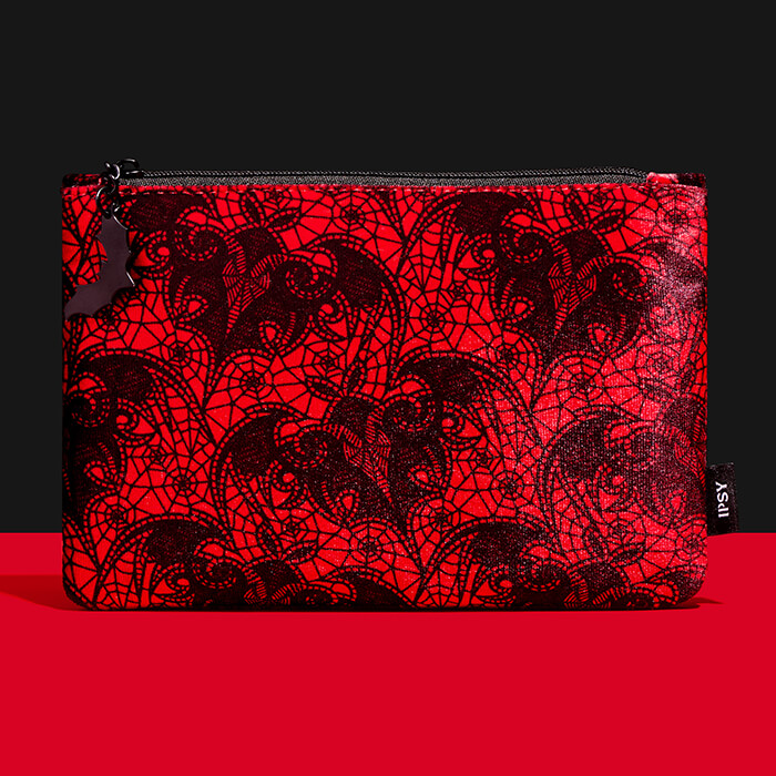October 2023 IPSY Glam Bag on black ground and red surface