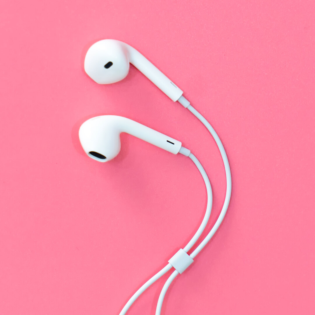 White earphones on pink background