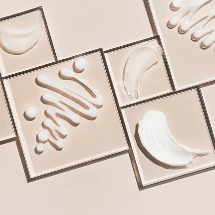 Different gel moisturizers swatched inside square frames on beige background